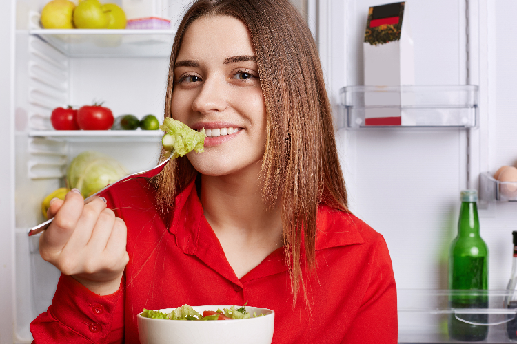 キャベツを食べる女性